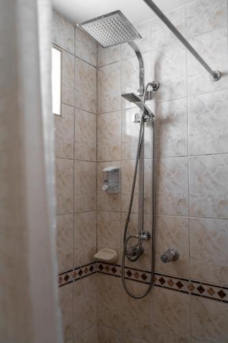 a bathroom with a shower with a shower head at Hotel La Posada de Atahualpa in Cusco