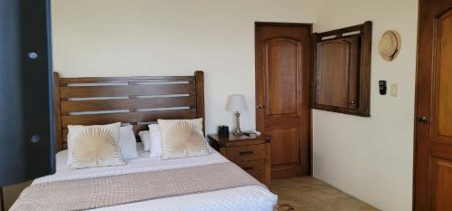a bedroom with a bed with a wooden headboard at Casa Aramana in Vieques