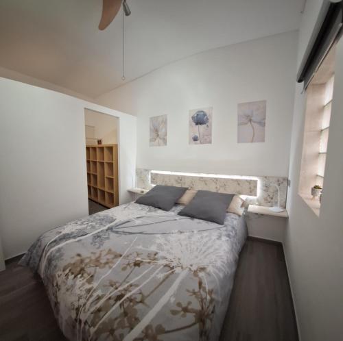 a bedroom with a bed in a white room at Casita Leos in Agüimes