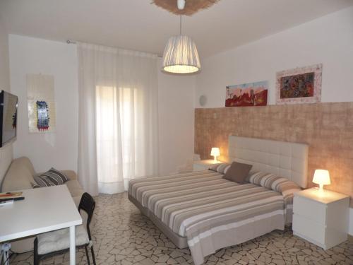 a bedroom with a bed and a table and a desk at Casa Piazza del Santo in Padova