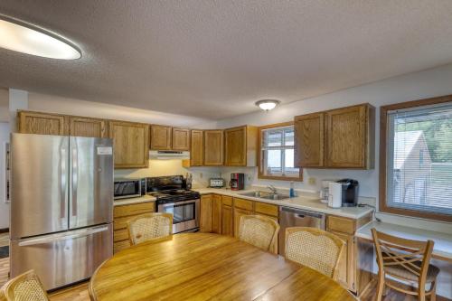 a kitchen with a wooden table and a stainless steel refrigerator at Buffalo Thunder Lodge in Deadwood