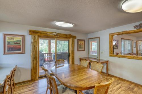 a dining room with a wooden table and chairs at Buffalo Thunder Lodge in Deadwood