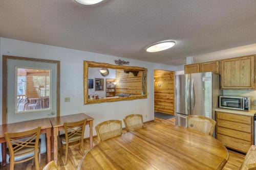 a kitchen and dining room with a table and a refrigerator at Buffalo Thunder Lodge in Deadwood