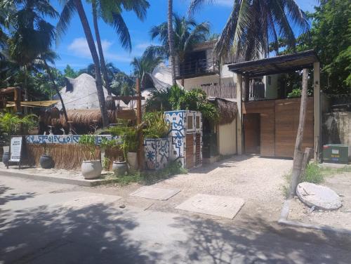 a house with blue and white graffiti on it at Sunset House in Tulum
