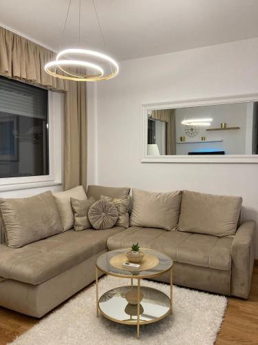 a living room with a couch and a table at Apartman 10 Lux in Novi Sad