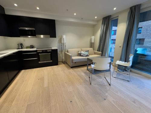 a kitchen and living room with a couch and a table at Oslo City Center Opera House Munch Museum Your Second Home in Oslo