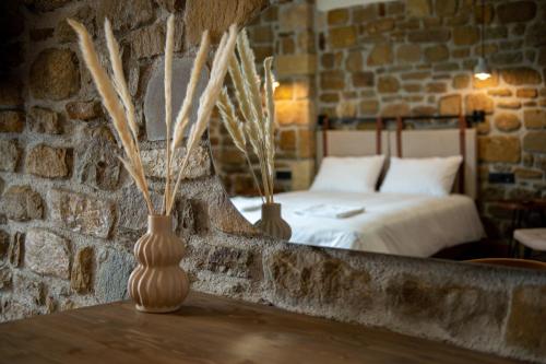 a bedroom with a bed and two vases on a table at Άνδηρο in Synikia Mesi Trikalon