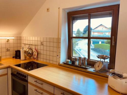 a kitchen with a sink and a window in it at Wohnung Turmblick in Marktoberdorf