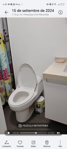 a bathroom with a white toilet and a counter at Apartamento de estreno in Arequipa
