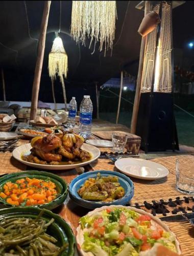 a table with many plates of food on it at Villa Diaf Johanne in Aït Ourir