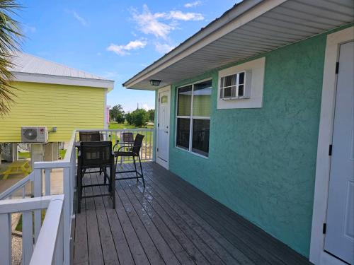 a deck with chairs and a table on a house at Old Wooden Bridge Resort & Marina in Big Pine Key