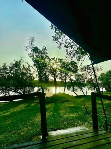 a tent with a view of a lake and trees at Nsobe Game Camp in Masaiti