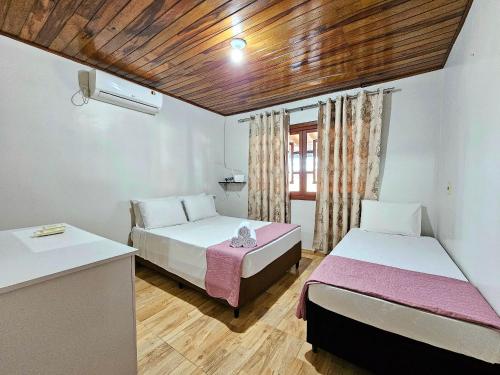 Katil atau katil-katil dalam bilik di Casa Familiar Espaço Amplo com churrasqueira