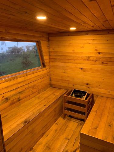 a wooden cabin with a stove in the corner at El Barranquero cabaña La Tangara in Cali
