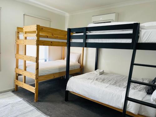 a room with two bunk beds and a bed at D110 Sweet Melon super stay-fantastic in Braybrook