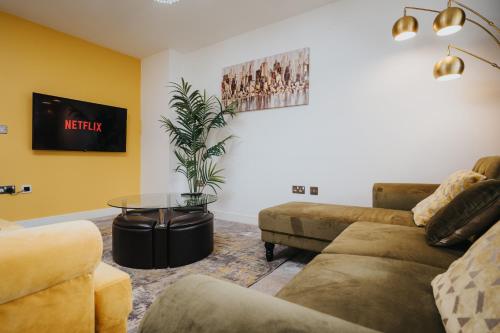 a living room with a couch and a table at Pool Table - Coop Live Arena, Etihad & City stay in Manchester