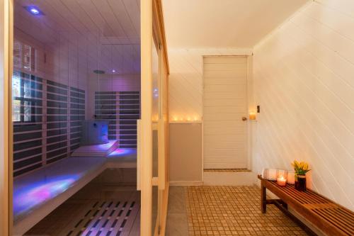 a sauna with a bench and a tub in a room at ABC Stay - Connecticut Five Bedroom Home in Warren