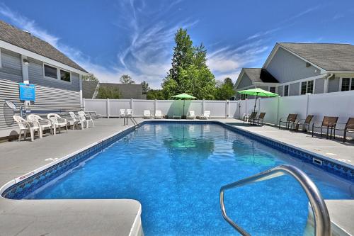 a swimming pool with chairs and a fence at Cozy Studio at Killington Center - Close to it all with pool and shuttle bus access! 441 in Killington