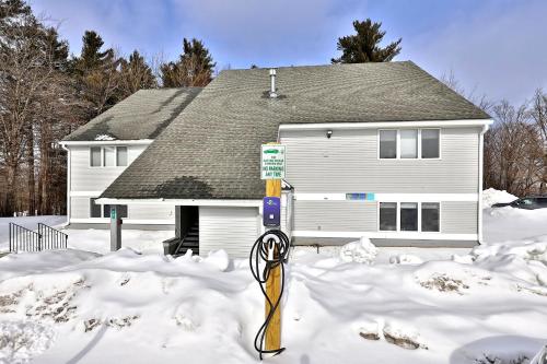 a parking meter in the snow in front of a house at Cozy Studio at Killington Center - Close to it all with pool and shuttle bus access! 441 in Killington