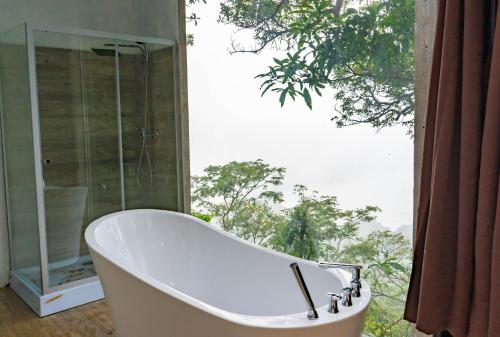 a bath tub in a bathroom with a large window at Tres Piedras in San Francisco Chinameca