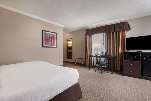 a hotel room with a bed and a desk at Best Western Little River Inn in Simcoe