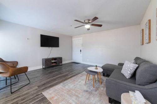 a living room with a couch and a flat screen tv at Walk to ATT-Glblife-Free Parking-Min to attraction in Arlington