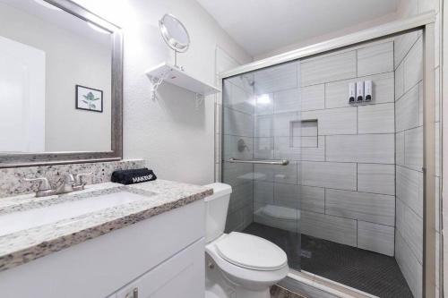 a white bathroom with a toilet and a shower at Walk to ATT-Glblife-Free Parking-Min to attraction in Arlington