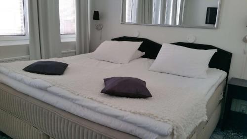 a bed with two pillows on it in a bedroom at Best Western Hotel Apollo in Oulu