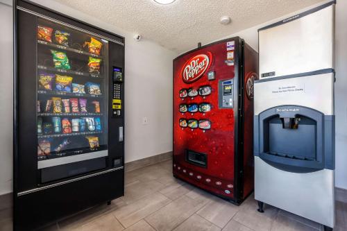 a coca cola vending machine next to a soda machine at Motel 6 Fort Worth, TX East in Fort Worth