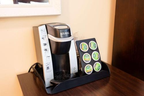 a coffee maker sitting on top of a table at Fireside Inn & Suites Portland in Portland
