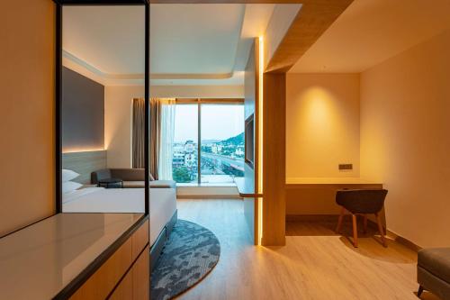 a hotel room with a bed and a desk and a window at Park Inn by Radisson Vellore in Vellore