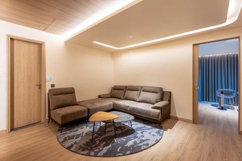 a living room with a couch and a table at Park Inn by Radisson Vellore in Vellore