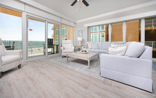 a living room with white furniture and large windows at Phoenix Gulf Towers 405 condo in Gulf Shores