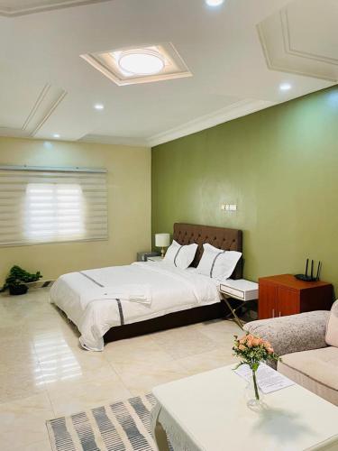 a bedroom with a large bed and a couch at Les HOTELS TALHAYA, NOUAKCHOTT in Nouakchott