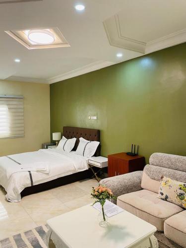 a bedroom with a large bed and a couch at Les HOTELS TALHAYA, NOUAKCHOTT in Nouakchott