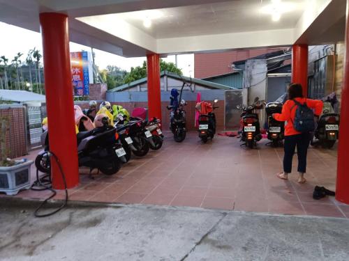 a group of motorcycles parked in a garage at 長龍客棧 in Nantou City