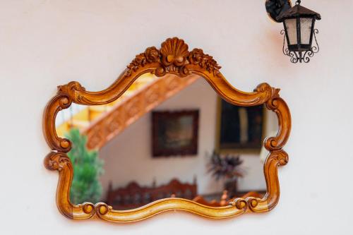 an ornate gold mirror hanging on a wall at Hotel La Posada de Atahualpa in Cusco