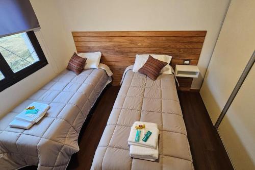 two beds in a small room with towels at Ush in Ushuaia