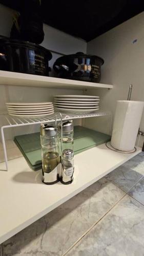 two glasses sitting on a shelf in a kitchen at Ush in Ushuaia