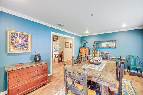 a dining room with blue walls and a wooden table at Del Rio Home with Large Yard, BBQ and Fireplace! in Del Rio