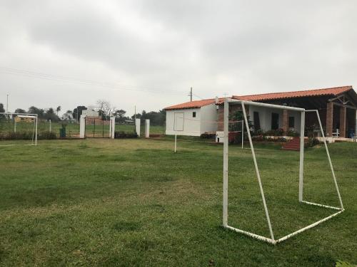 a group of soccer nets in a field in front of a house at Casa Quinta Sagrada Familia de Nazaret in Guarambaré