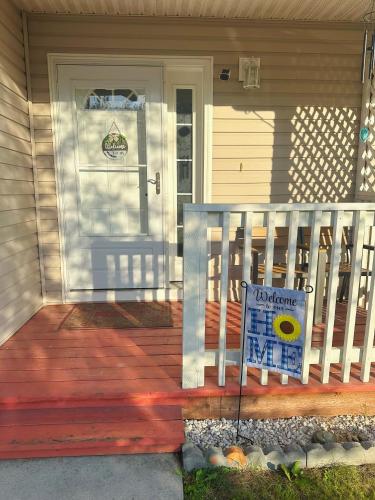 a porch with a welcome sign in front of a door at Easystay in Fairbanks