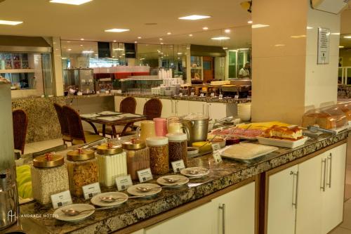 a buffet of food on a counter in a restaurant at Rede Andrade Solmar in João Pessoa