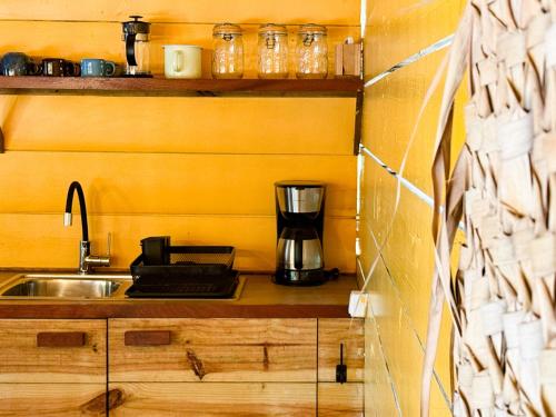 a kitchen with a sink and a coffee maker on a counter at Jan Kok Lodges in Willibrordus