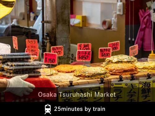 a display of food on a table with signs at MERBABU STAY OSAKA in Osaka