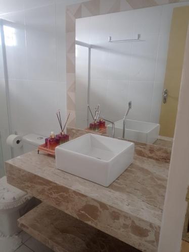 a bathroom with a large white sink on a counter at Casa aconchegante - Morada do Sol in Piranhas