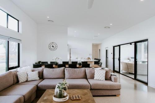 a living room with a couch and a table at Mudgee Haven - Stunning Terra Modern Design in Mudgee