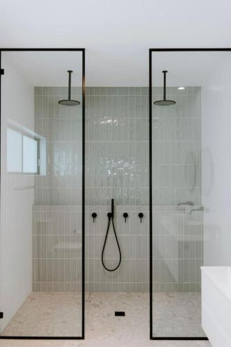 a bathroom with a shower with glass doors at Mudgee Haven - Stunning Terra Modern Design in Mudgee
