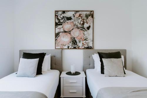 two beds sitting next to each other in a bedroom at Mudgee Haven - Stunning Terra Modern Design in Mudgee