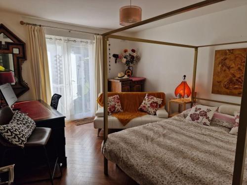 a bedroom with a bed and a chair and a desk at Trinity Cottage 2 bed with mezzanine in Dublin